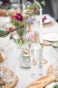 Glassware arranged for dinner on table during party at building terrace