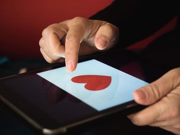Close-up of person holding hands on table