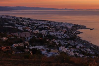 View of cityscape and sea during sunset