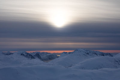 Scenic view of snowcapped mountains against sky during sunset