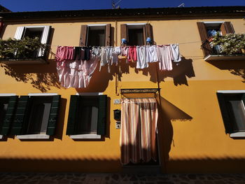 Low angle view of clothes drying outside building