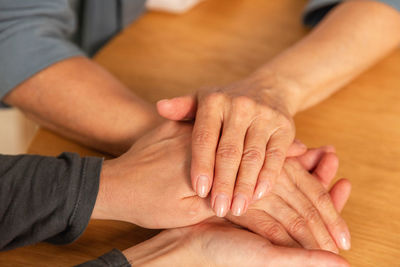 Low section of couple holding hands