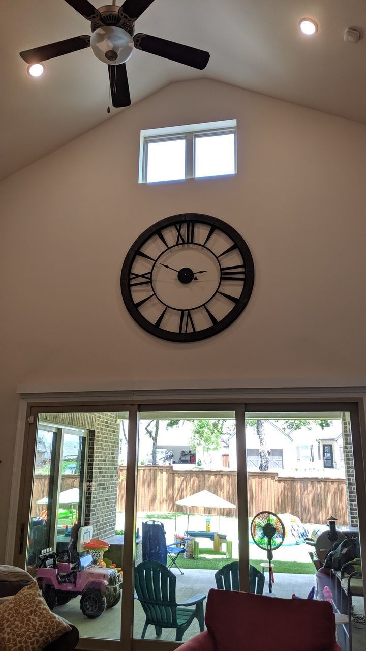 CLOCK ON TABLE AGAINST ILLUMINATED WALL