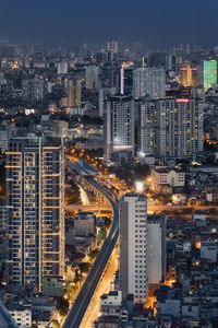 High angle view of illuminated buildings in city at night