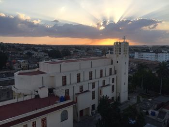 Cityscape against sky at sunset