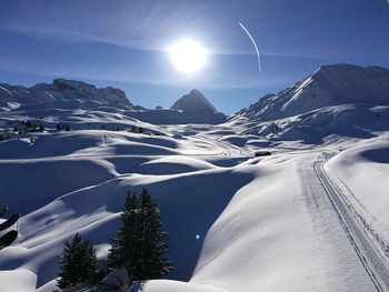 Scenic view of snow covered mountains against sky