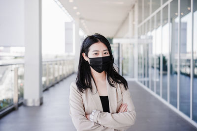 Young business woman wearing face mask in city. corona virus concept