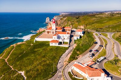 High angle view of buildings by sea against sky