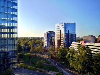 View of city buildings against clear sky