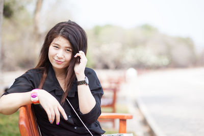 Close-up of young woman using mobile phone outdoors