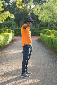 Rear view of man walking on road