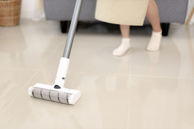 Low section of woman standing on floor