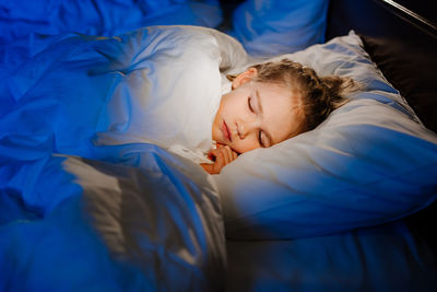 High angle view of people sleeping on bed