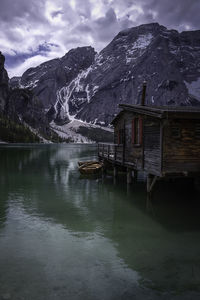 Scenic view of lake by snowcapped mountains against sky