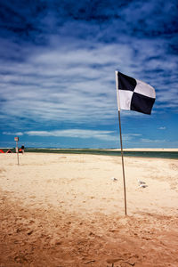 Lifeguard hut on beach against sky