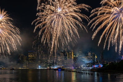 Firework display in city at night