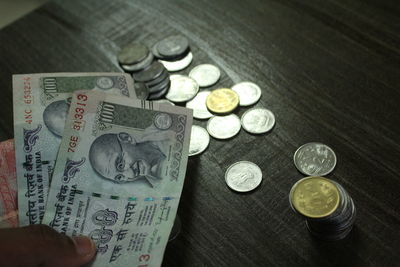 Cropped hand of person holding paper currency