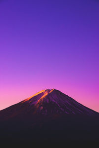 View of volcanic mountain against sky during sunset