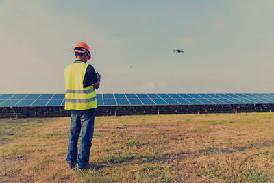 Man standing on field against sky