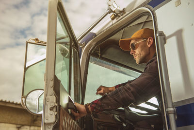 Driver opening door of truck