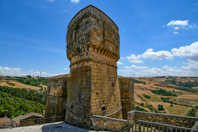 A tower of a medieval castle in a village of puglia region, italy.