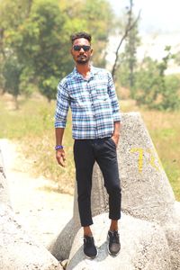 Portrait of young man standing on road