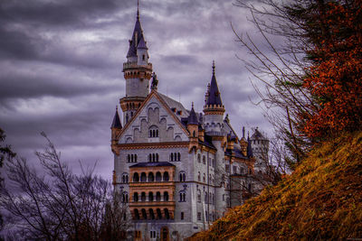 Low angle view of historic building against cloudy sky