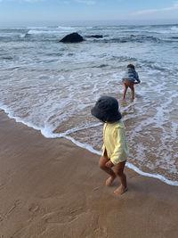 Rear view of boys on beach