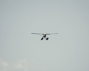 Low angle view of airplane against clear sky