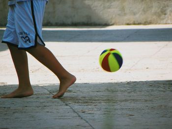 Low section of person playing soccer on field