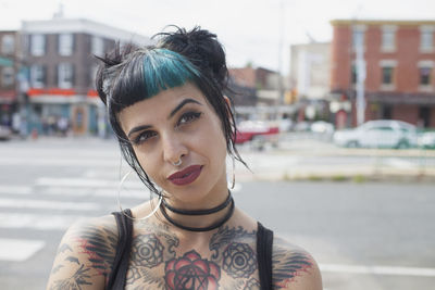 Portrait of young woman on city street