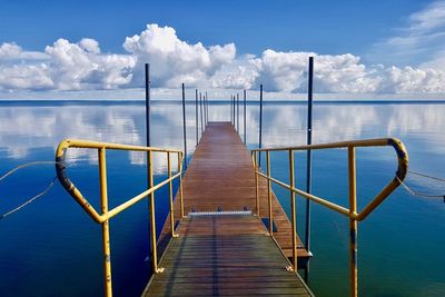 Pier over sea against sky