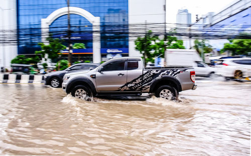 Car on street against buildings in city