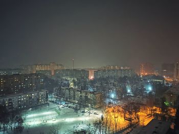 High angle view of illuminated buildings in city at night