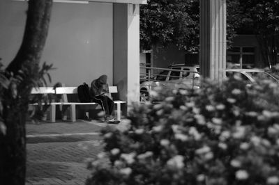 People sitting on chair against plants