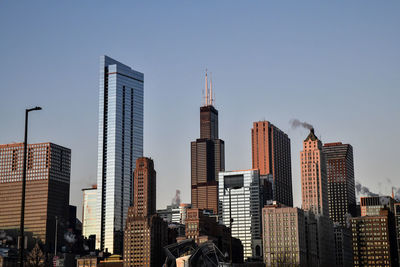 Low angle view of skyscrapers against clear sky