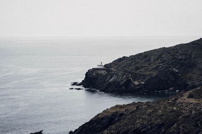 Rock formations by sea against sky