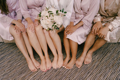 Low section of women sitting on floor