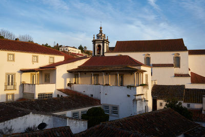 Houses in city against sky