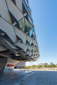 Low angle view of modern building against clear blue sky