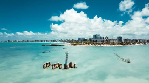 Panoramic view of sea and buildings against sky