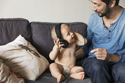 Father with baby on sofa