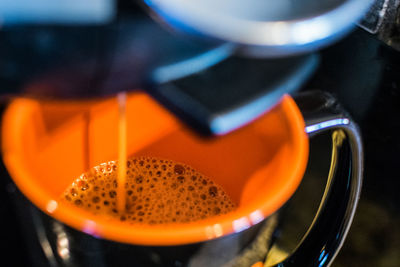 Close-up of espresso maker pouring coffee in cup