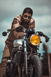 Man riding motorcycle on cloudy day