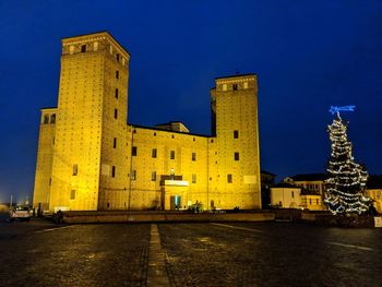 Illuminated tower in city at night