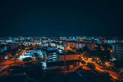 Illuminated cityscape against sky at night