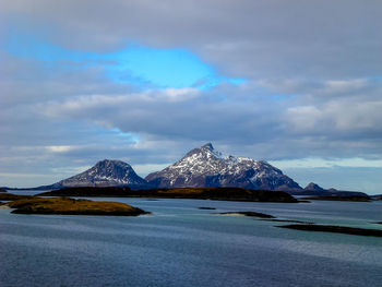 Scenic view of lake and snowcapped mountains against sky