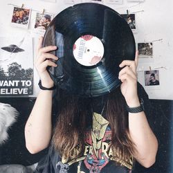 Full length portrait of young woman holding text