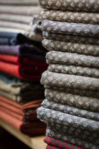 Close-up of fabrics stacked on rack for sale