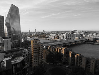 High angle view of buildings against cloudy sky